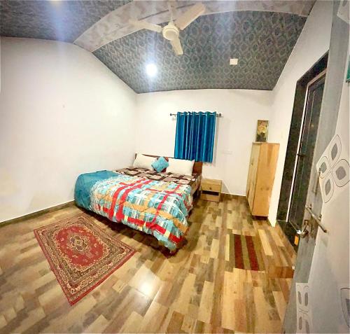 a bedroom with a bed and a wooden floor at sukhwan BY WILD FLOWER in Mulshi