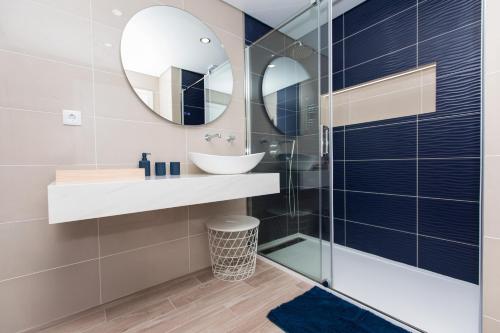 a bathroom with a sink and a mirror at SeaSimbra Apartment in Sesimbra
