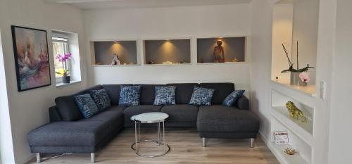 a living room with a couch and a stool at Cozy Villa in Rødby