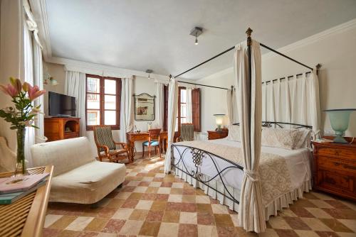 a bedroom with a bed and a living room at Son Sant Jordi in Pollença