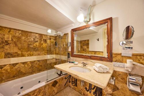a bathroom with a sink and a tub and a mirror at Son Sant Jordi in Pollença