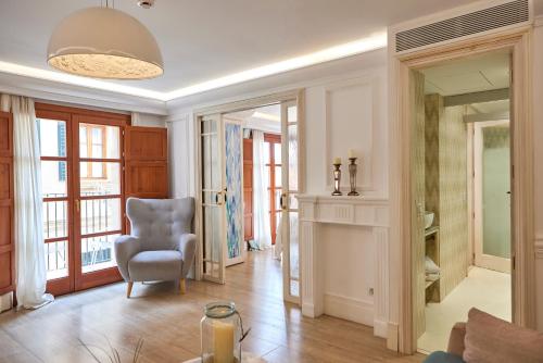 a living room with a chair and a window at Son Sant Jordi in Pollença