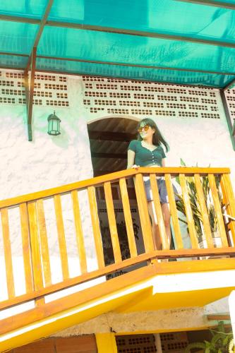 a doll of a woman sitting on a balcony at Plaza Muyuyo in Data de Villamil