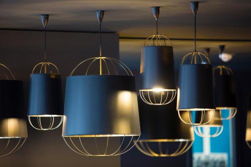 a bunch of lights hanging from a ceiling at Nomad Hotel le Havre Centre Gare in Le Havre