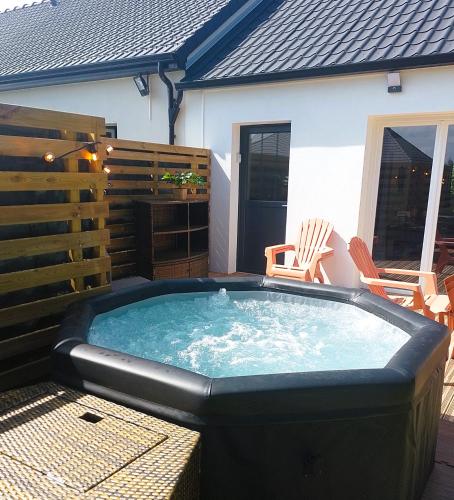 a large hot tub sitting on a patio at Gite des Plantis in Senneville-sur-Fécamp