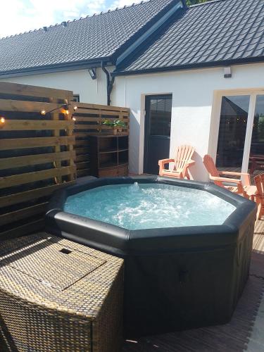 a large hot tub in the backyard of a house at Gite des Plantis in Senneville-sur-Fécamp