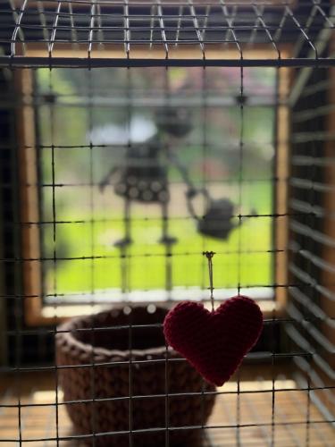 a heart on a wire cage with a window at Alice Chalet Bled - Adults only in Bled