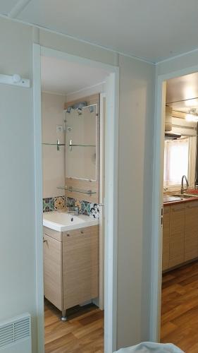 une salle de bain avec une baignoire et un lavabo dans l'établissement MOBILE HOME tout confort à 200m de la plage, à Hyères