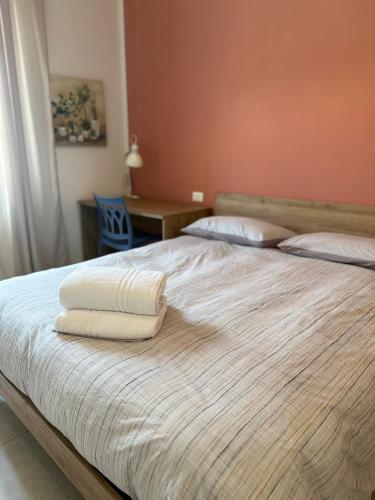 a bedroom with a bed with two towels on it at Locanda Francini in Badia A Passignano