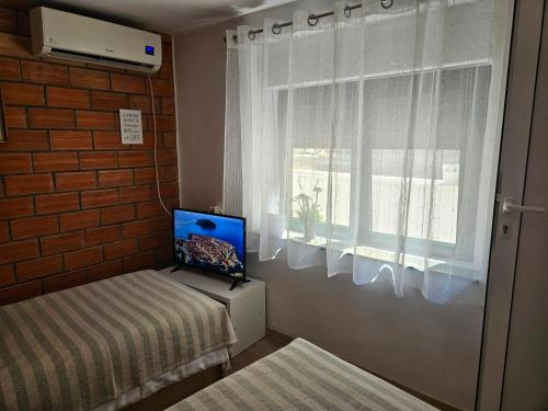 スプリトにあるApartment Gagoの窓、ベッド、テレビが備わる客室です。