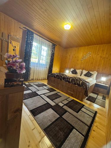 a bedroom with a bed and a large rug at Casa DanAdy in Sibiu