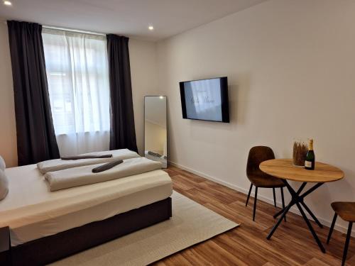 a bedroom with a bed and a table and a mirror at Süße Marie 17 in Karlsruhe