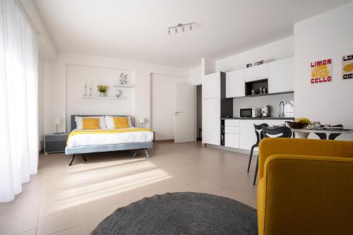 a bedroom with a bed with yellow pillows in it at Regina Apartments in Mazara del Vallo