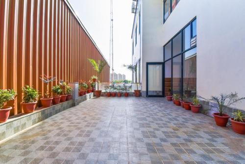 a hallway with potted plants on the side of a building at Hotel GD Palace in Mohāna