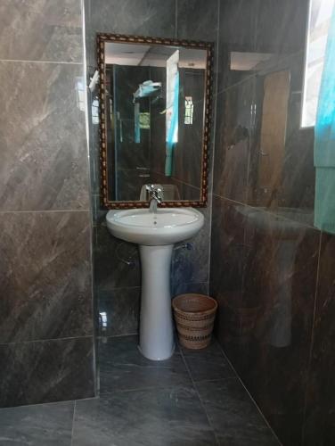 a bathroom with a sink and a mirror at Capricorn by Quest-Cape Maclear in Chembe