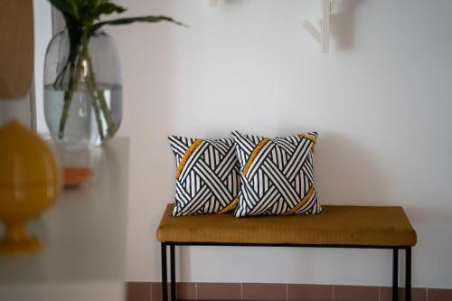 a bench with two pillows on it in a room at Regina Apartments in Mazara del Vallo
