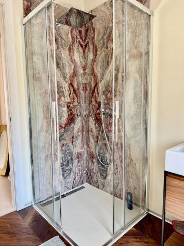 a shower in a room with a painting on the wall at Top floor design apt, 3bd, 2bt! in Colico
