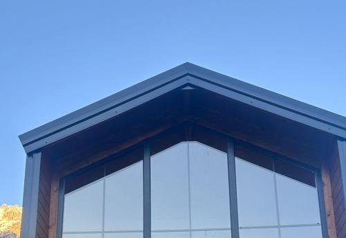 a building with glass windows on the top of it at SeSam Villas in Theth