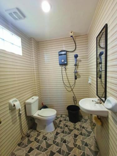 a bathroom with a toilet and a sink at Virginia Homestay 1North Siargao in Burgos