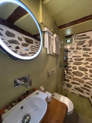a bathroom with a sink and a mirror at Atelies Stone House in Potamia
