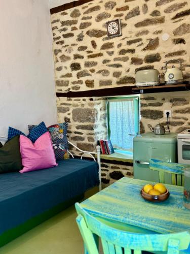 a living room with a couch and a table at Atelies Stone House in Potamia