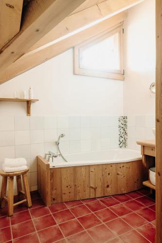 une salle de bain avec une baignoire et une fenêtre dans l'établissement Le Chalet Hôtel Cordon Adults Only, à Cordon