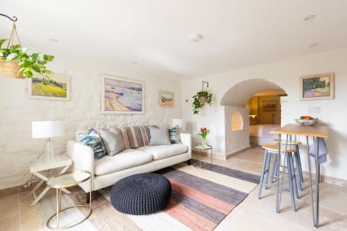 a living room with a couch and a table at OWH Studio by The Butler Collection in Arundel