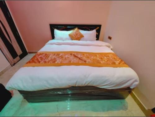 a bedroom with a large bed in a room at Hotel New Shree Ram Palace in Ayodhya