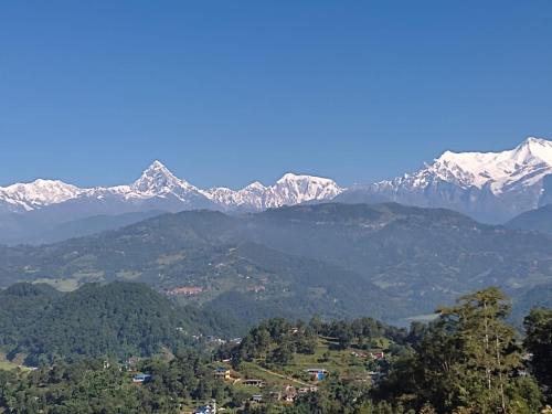 a view of a mountain range with snow covered mountains at Hotel Lekhnath View Tower and Eco Farm in Deorāli