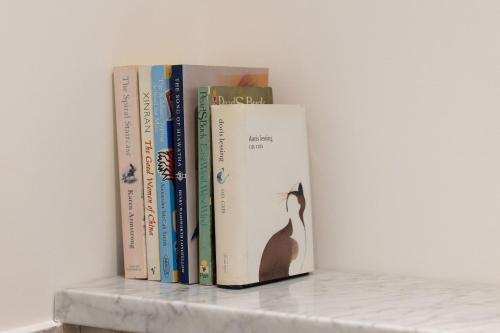 a group of books sitting on a shelf at OWH Studio by The Butler Collection in Arundel