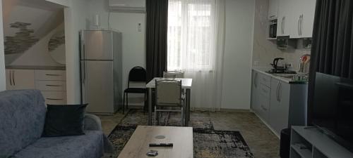 a living room with a couch and a table at Guesthouse Next to beach in Batumi