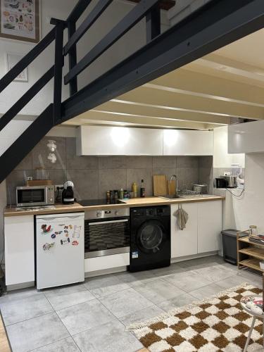 Il comprend une cuisine équipée d'une cuisinière et d'un lave-vaisselle. dans l'établissement Comfortable 40 m love cocoon, à Lyon