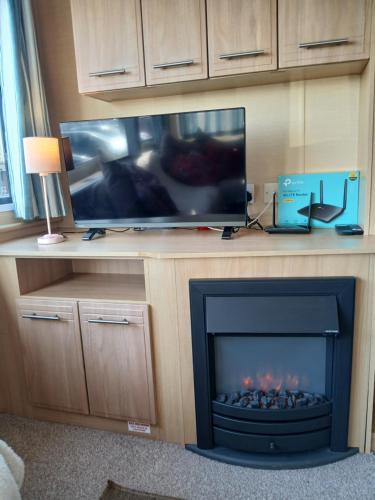 a fireplace in a living room with a tv and a fire place at L91 Rebecca's place in Mablethorpe