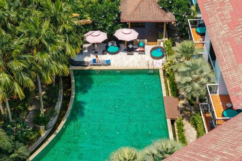 an overhead view of a swimming pool at a resort at Coco Retreat Phuket Resort and Spa - SHA Plus in Chalong
