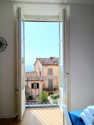 an open door to a balcony with a view of a building at La Piazzetta in Veroli