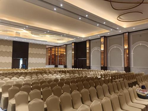 an empty auditorium with rows of chairs in a room at Enrise by Sayaji Bhopal in Bhopal