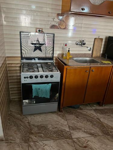 a kitchen with a stove and a sink at Valley Of The Kings House in Luxor