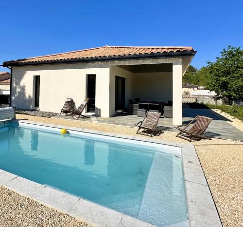 a swimming pool in front of a house at Villa Dyane in Salavas