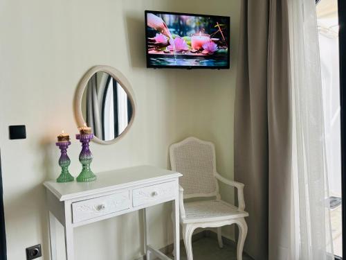 a room with a white dresser and a mirror at Memories in Ornos