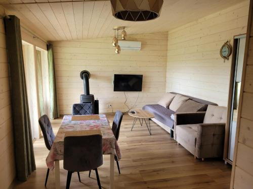 a living room with a table and a couch at Apartement u Jędrusia w ogrodzie in Żywiec