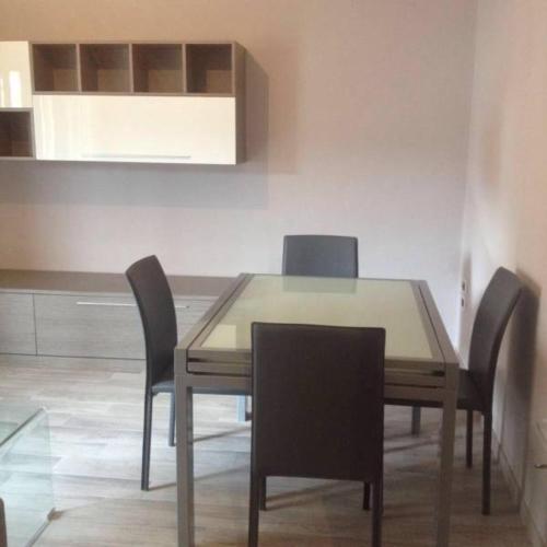 a dining room table and chairs in a room at Fiordaliso in Caulonia Marina