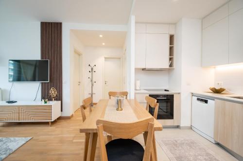 a kitchen and dining room with a table and chairs at BW Vista in Belgrade