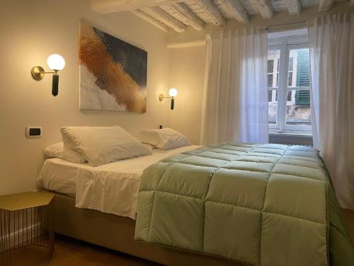 una camera da letto con un letto grande e una finestra di Antica Residenza del Gallo a Lucca