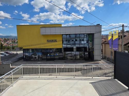 a store front with a yellow and white building at Sarajevo Pulse Residence in Sarajevo