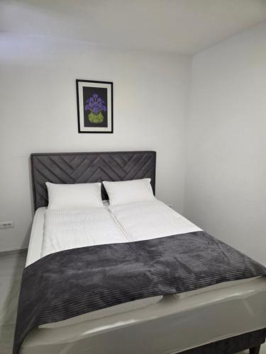 a bed in a bedroom with a black and white mattress at Sarajevo Pulse Residence in Sarajevo