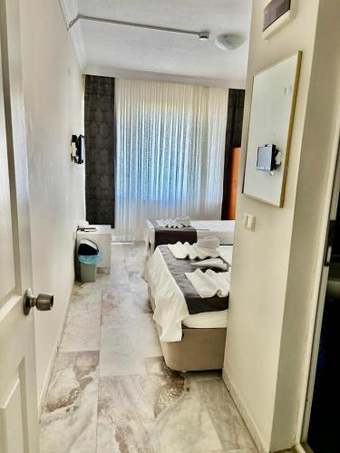 a hotel room with a bed and a bathroom at THE BEACH SUN OTEL DİDiM in Didim