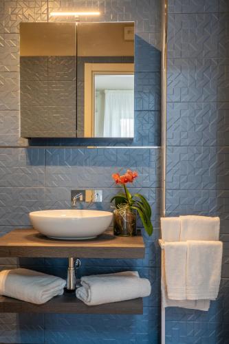 a bathroom with a sink and a mirror at Hotel Baia di Talamone in Talamone