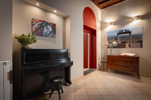 a room with a piano and a wooden dresser at Modern Apartments in Palestrina