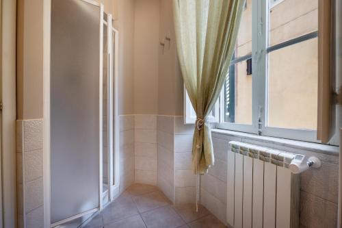 a bathroom with a window and a radiator at Modern Apartments in Palestrina