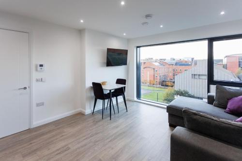 a living room with a couch and a table at Modern 2 Bedroom Apt in Belfast in Belfast